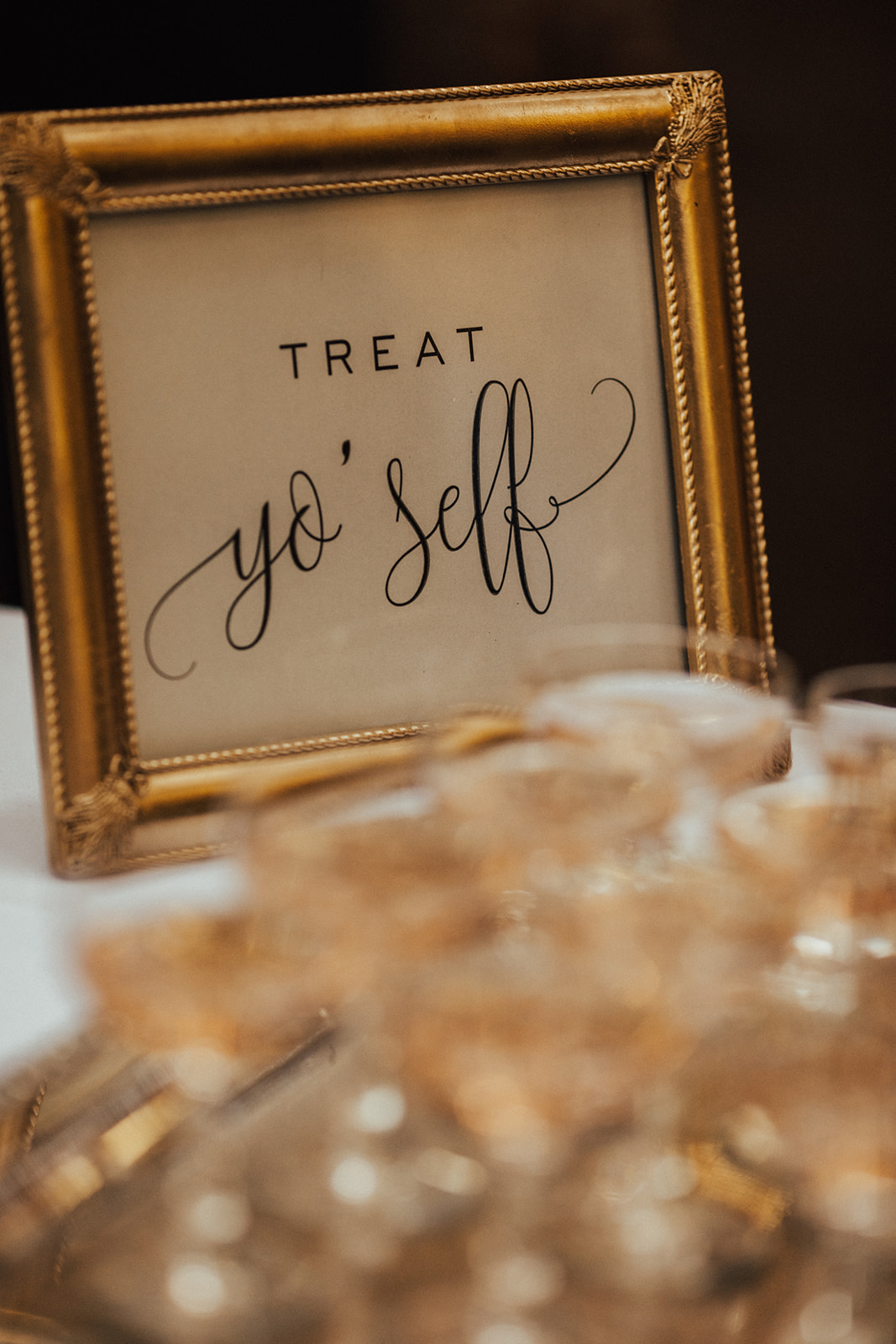 Framed Treat Yo Self sign beside the wedding dessert display